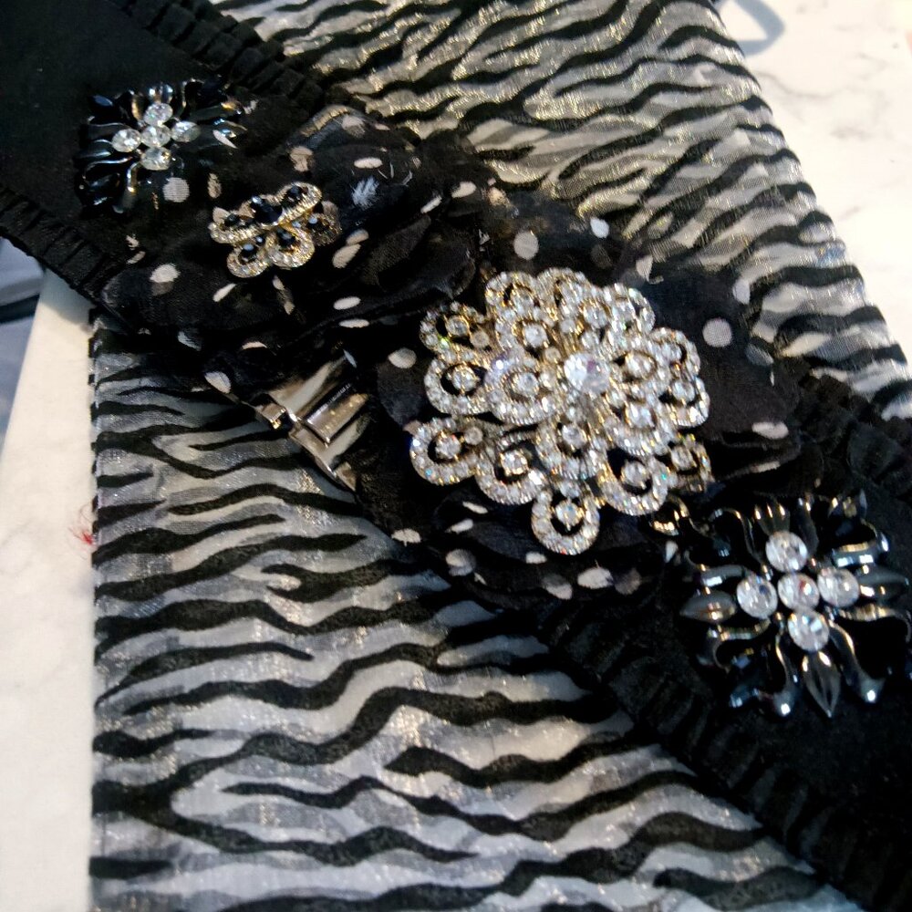 A handmade stretch belt created in black and white with lots of sparkle